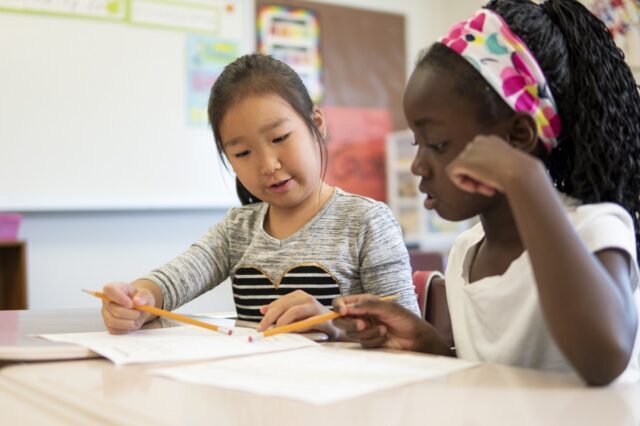 A close-up of a student practicing a new literacy skill on a whiteboard during the "we do" portion of a systematic lesson.