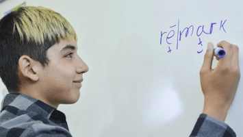 International student using markup on a whiteboard