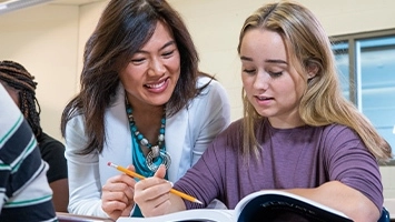 A teacher works with an individual student.