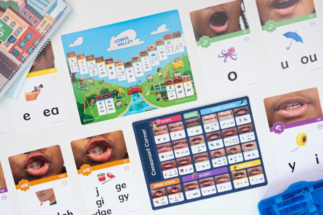 A student holding a portable Sound Wall card used to help identify and confirm letter-sound relationships during spelling practice.
