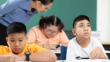 Students and their teacher in a special education classroom.
