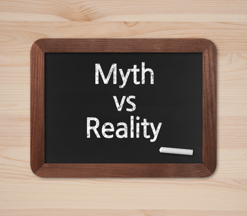 chalkboard with myth vs. reality and a piece of chalk