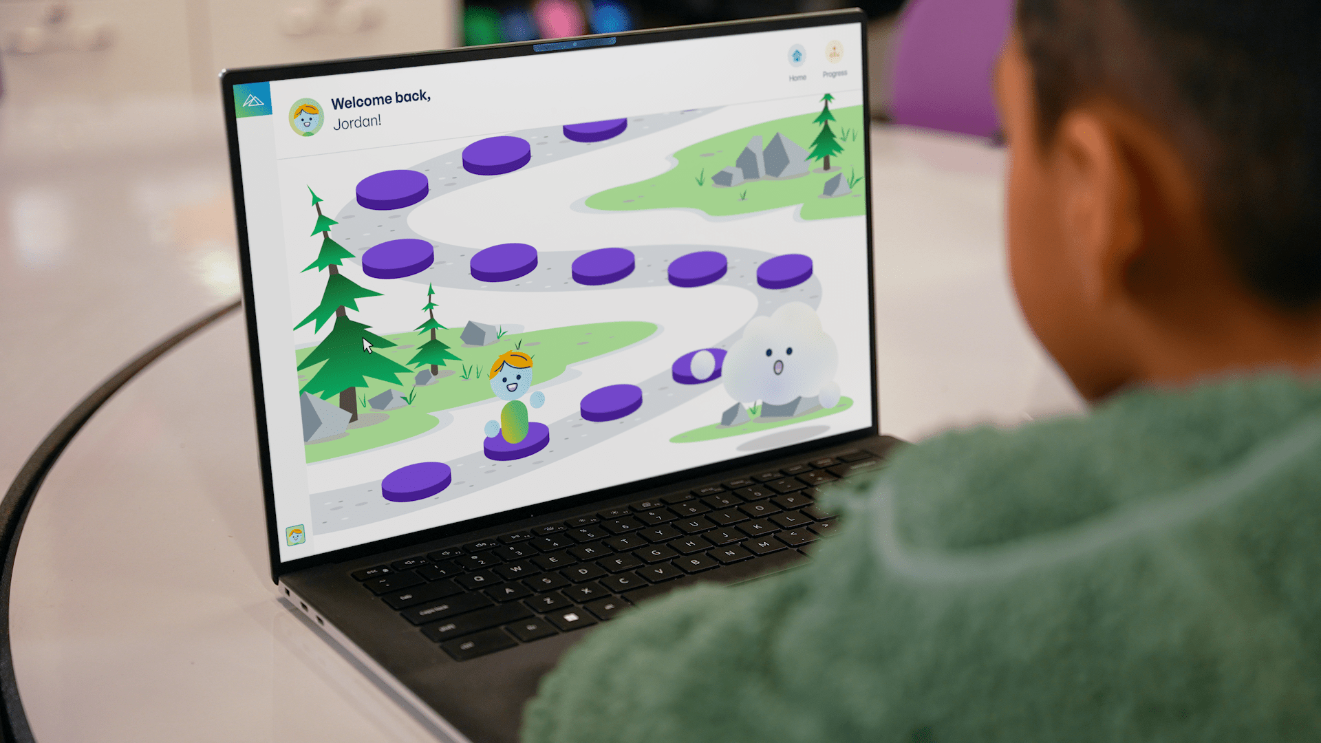 Student uses a laptop to navigate a gamified learning path activity.