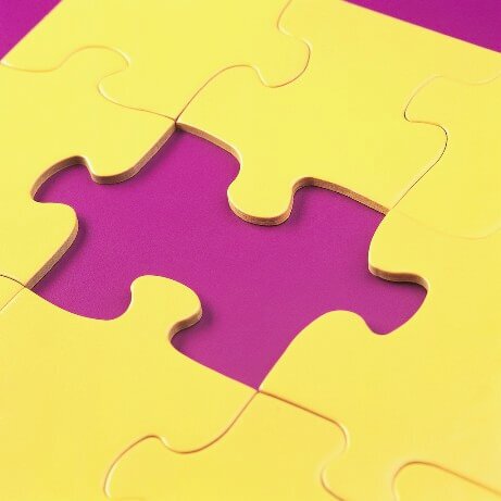 A conceptual image featuring a purple puzzle piece being fitted into a yellow background, representing the missing piece of phonological awareness in ESL reading instruction.