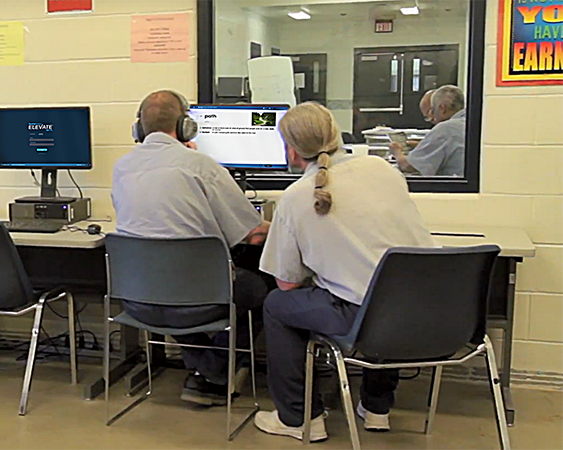 two men in prison using Reading Horizons Elevate to learn to read.