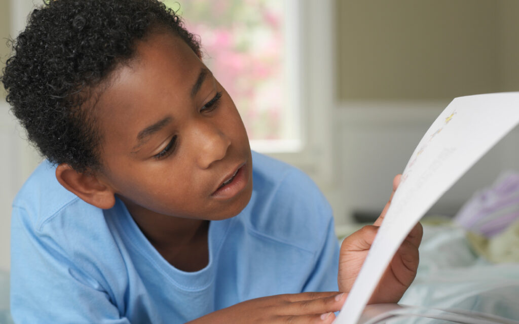 young boy reading