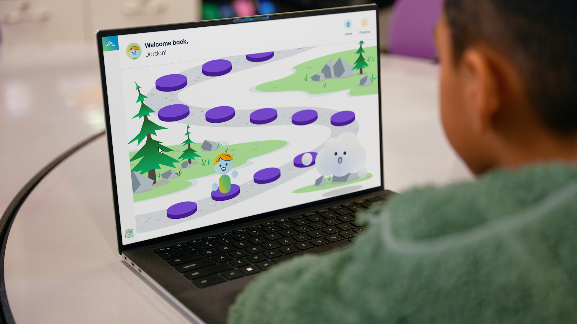 Student uses a laptop to navigate a gamified learning path activity.